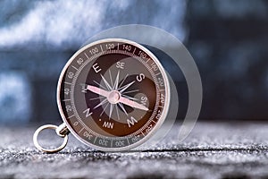 Travel planning navigation concept. Classic black magnetic detail of compass on light blue backround.