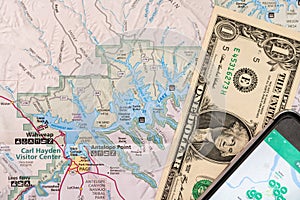 Travel planning with smart phone and travel map, detail of Arizona, USA map, Lake Powell, one Dollar bill