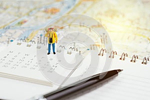 Travel planning or year plan for vacation or start new journey concept, miniature people traveller, backpacker man standing on