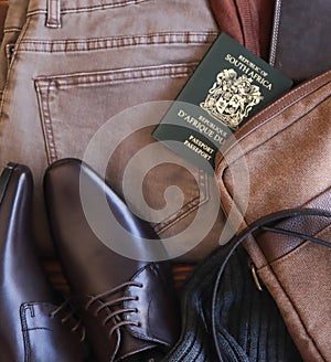 Travel plans with passport shoes trousers belt scarf wallet