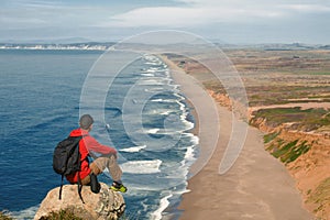 Travel in Point Reyes National Seashore, hiker man with backpack enjoying scenic view, California, USA