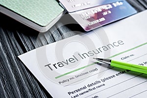 Travel preparation concept with insurance and cards on wooden ta