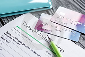 Travel preparation concept with insurance and cards on wooden table