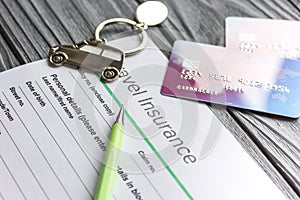 Travel preparation concept with insurance and cards on wooden table