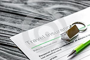 Travel preparation concept with insurance on wooden table
