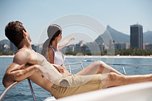 Travel, relax and couple on boat in ocean for cruise, luxury sailing and transport on holiday, vacation and trip. Dating