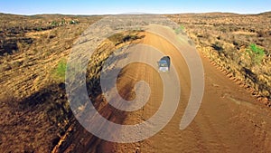 Travel, sand and desert with truck in dirt road of Australia countryside for freedom, transportation or journey