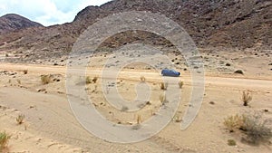 Travel, sand and desert with truck in dirt road of countryside for freedom, transportation or journey. Adventure