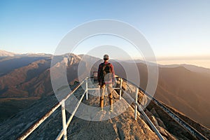 Travel in Sequoia National Park, man Hiker with backpack enjoying view Moro Rock, California, USA photo