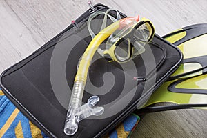 Travel set on suitcase with accessories for snorkeling