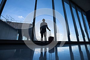 Travel, silhouette of passenger in airport, man with luggage waiting for the flight