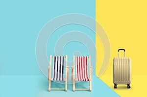 Travel suitcase and beach deck chairs