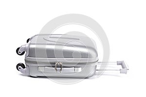 Travel suitcase isolated. Silver plastic luggage or vacation baggage bag on white background. Design of summer vacation