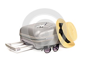 Travel suitcase isolated. Travel accessories with suitcase, straw hat, toy airplane in minimal trip vacation concept isolated on