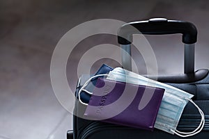 Travel suitcase, passport and mask. The ban on travel during the epidemic of the coronavirus and the introduction of quarantine photo