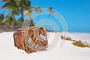 Travel suitcase toy on the beach