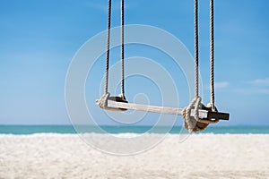 Travel and summer background, wooden swing on the beach with white sand, turquoise water and blue sky. Freedom life relax time. P