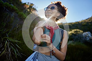 Travel, sunshine and woman with sunglasses in nature for hiking in morning, adventure or explore outdoor. Smile, freedom