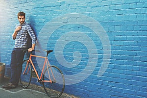 Travel, thinking and businessman with bicycle in city for job, opportunity or morning commute on wall background. Carbon