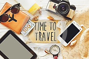 travel. time to travel concept text sign on card. summer planning vacation, flat lay. tablet, camera sunglasses compass passport