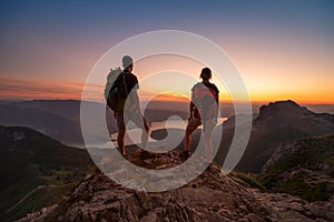 Travel to Alps mountains, tourists hikers with backpacks at sunset