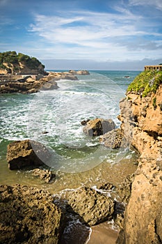 Travel to beautiful scenic colorful view on atlantic turquoise ocean with waves, coastline rocks in blue sky