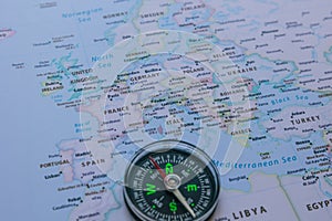 Travel to Europe background photo. A compass on the Europe map in focus.