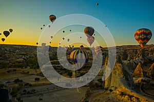 Travel to Goreme, Cappadocia, Turkey. The sunrise in the mountains with a lot of air hot balloons in the sky