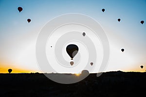 Travel to Goreme, Cappadocia, Turkey. The sunrise in the mountains with a lot of air hot balloons in the sky.