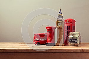 Travel to Great Britain concept with souvenirs and money box jar. Planning summer vacation