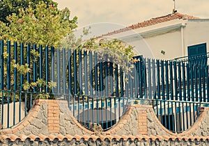 Travel to Italy -  historical street of Acitrezza, Catania, Sicily, facade of residental building with metal brick fence