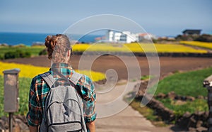 Travel to Jeju Island, South Korea, a young girl tourist walks on the background of blooming field