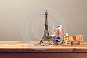 Travel to Paris, France concept with Eiffel Tower souvenir and wooden airplane toy. Planning summer vacation