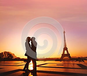 Paris romantic travel, silhouette of romantic couple kissing near Eiffel tower, France