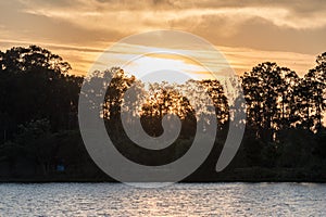 Travel to a portion of river with a natural scenery of sunset over a dock with lights photo