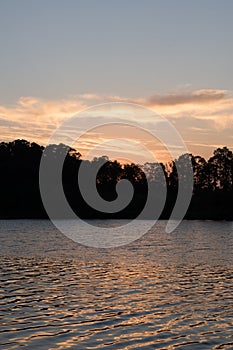 Travel to a portion of river with a natural scenery of sunset over a dock with lights photo