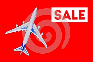 Travel and tourism concept. . Sale of air tickets and travel vouchers. Passenger aircraft on a red background