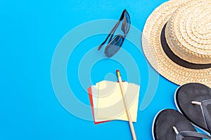 Travel and tourism concept with traveling accessories on blue background. Top view from above