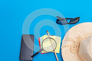 Travel and tourism concept with traveling accessories on blue background. Top view from above