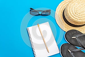 Travel and tourism concept with traveling accessories on blue background. Top view from above