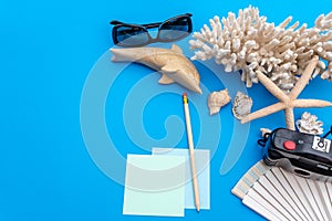 Travel and tourism concept with traveling accessories on blue background. Top view from above