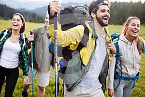 Travel, tourism, hike, gesture and people concept - group of smiling friends with backpacks