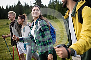 Travel, tourism, hike, gesture and people concept - group of smiling friends with backpacks