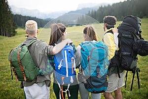 Travel, tourism, hike, gesture and people concept - group of smiling friends with backpacks