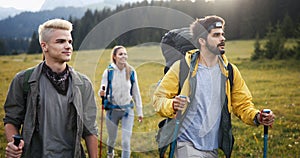 Travel, tourism, hike, gesture and people concept - group of smiling friends with backpacks