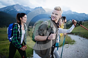 Travel, tourism, hike, gesture and people concept - group of smiling friends with backpacks