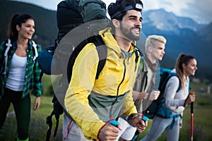 Travel, tourism, hike, gesture and people concept - group of smiling friends with backpacks