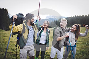 Travel, tourism, hike, gesture and people concept - group of smiling friends with backpacks