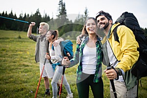 Travel, tourism, hike, gesture and people concept - group of smiling friends with backpacks