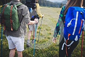 Travel, tourism, hike, gesture and people concept - group of smiling friends with backpacks